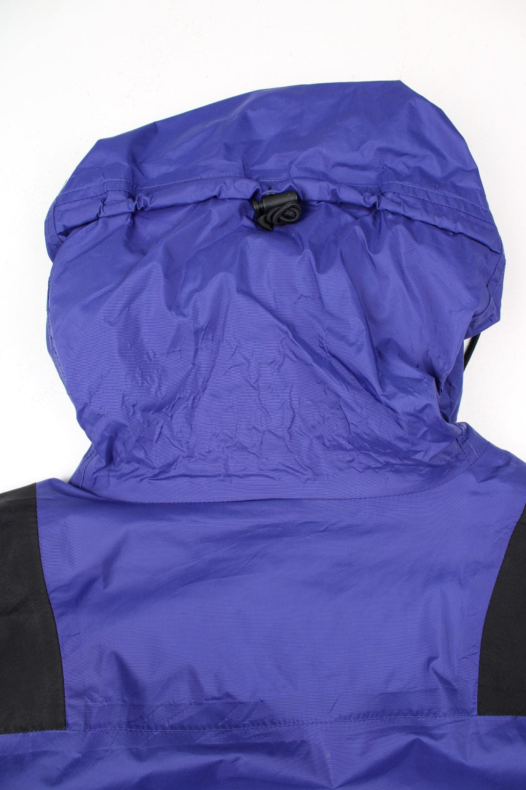 Vintage The North Face Mountain Light Jacket in a purple and black colourway. Zips and buttons up, has side pockets, hooded, and has the logo embroidered on the left sleeve.