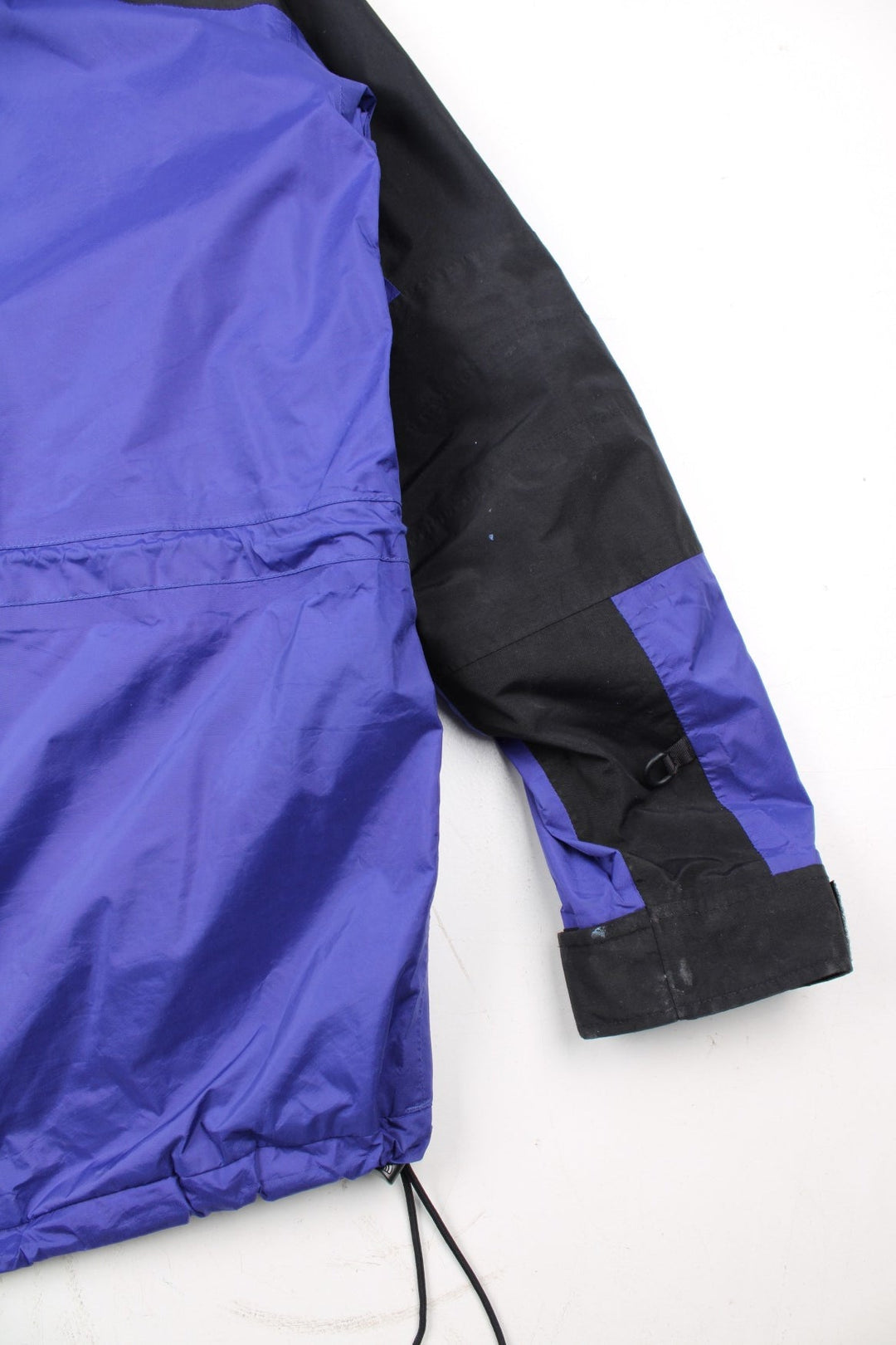 Vintage The North Face Mountain Light Jacket in a purple and black colourway. Zips and buttons up, has side pockets, hooded, and has the logo embroidered on the left sleeve.