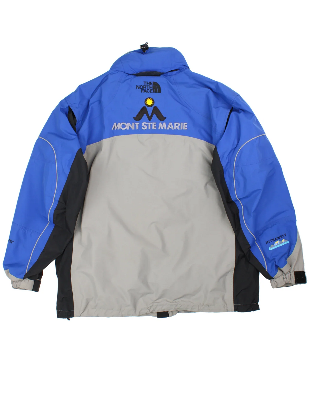 Vintage The North Face Mountain Ski Jacket in a blue/grey colourway. Zip fastening with hood and multiple zip pockets. Drawstring hem, mesh lining and has the logo embroidered on the front/back.