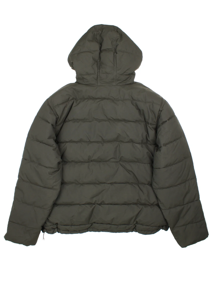 Carhartt Montana Puffer Coat in a black colourway, zips up and has multiple pockets, hooded and has the logo embroidered on the front.