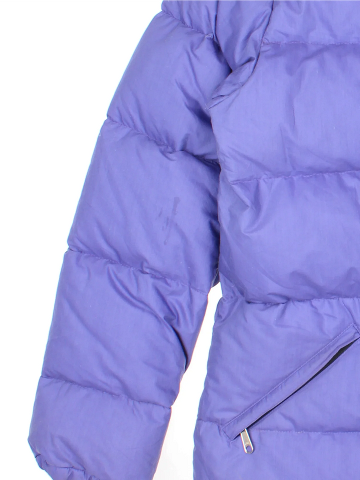 The North Face Puffer Coat in a purple colourway, full zip up and button up and has multiple pockets, hooded and has the logo embroidered on the front.