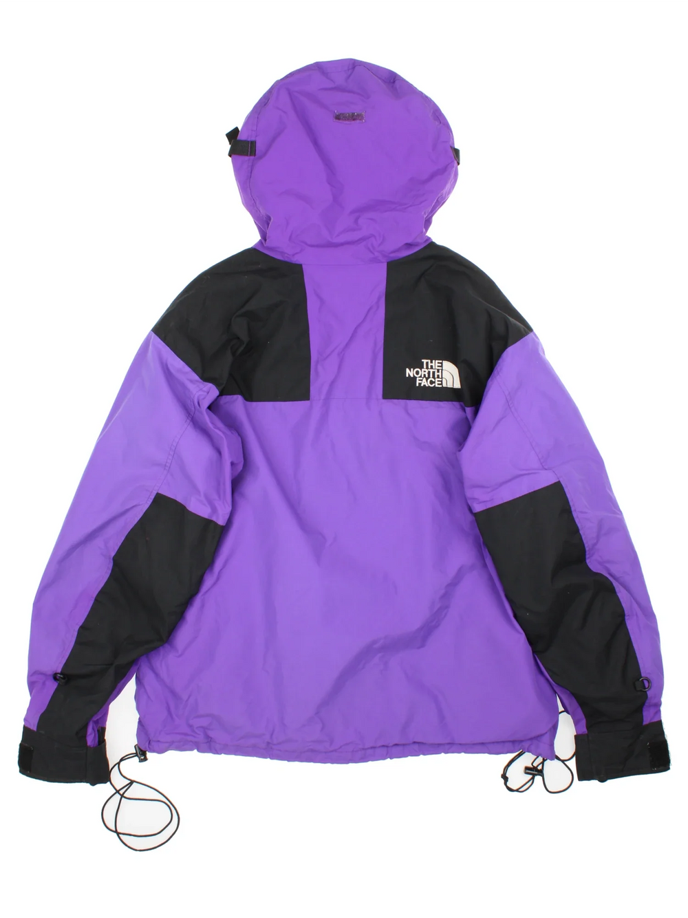 The North Face Gore-Tex Mountain Jacket in a purple colourway with black panelling, full zip up and button up. multiple pockets, hood, drawstring hem and has the logo embroidered on the sleeve and front.