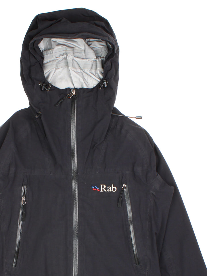 Vintage Rab Neutrino Jacket in a black colourway. Zip fastening with hood and zipped pockets. Contrast grey lining and embroided logo.