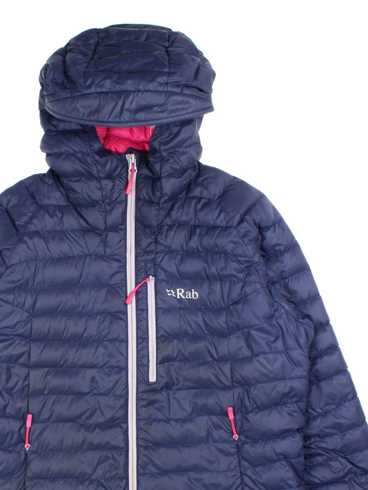 Vintage Rab Microlight Alpine Jacket in a blue colourway with contrast pink lining. Features hood, zip fastening/pockets and printed logo on the front.
