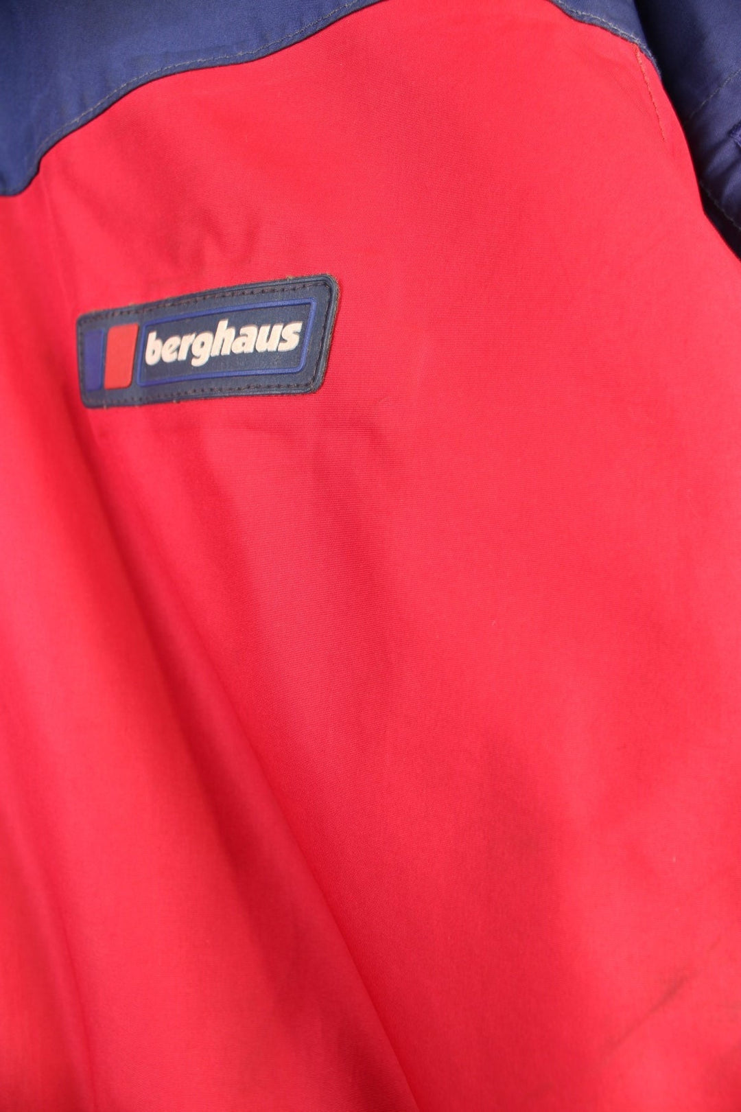 Vintage 90's Berghaus Mountain Trek Jacket in a red and blue colourway, zip up with side pockets, has a mesh lining, hooded and has the logo embroiderd on the front.
