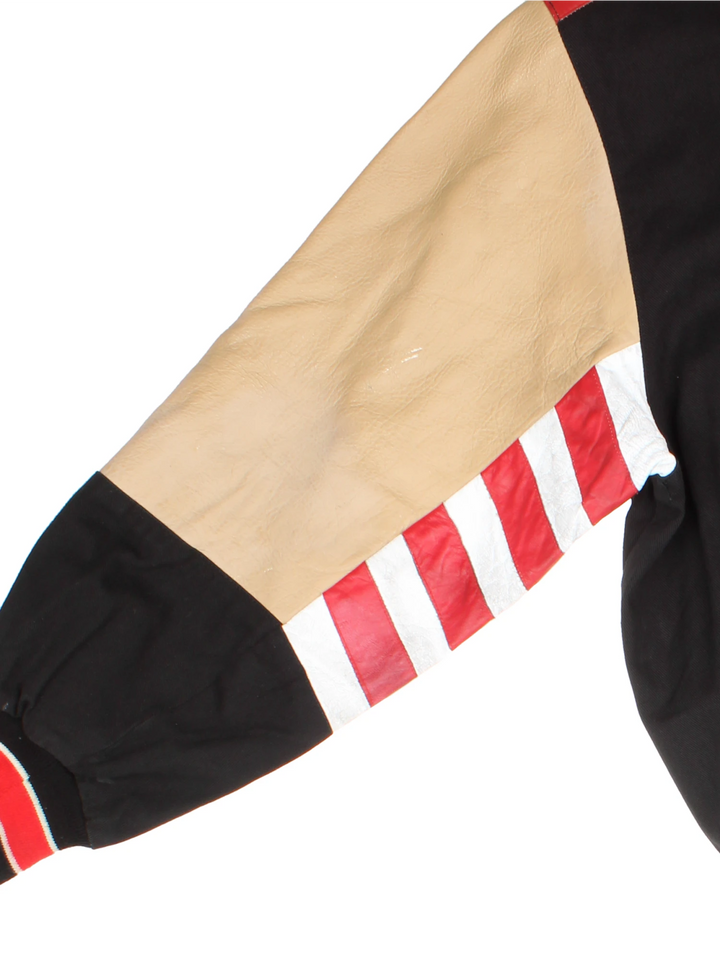 San Francisco 49s, NFL, Jeff Hamilton bomber-style pro sport jacket in a black colourway with white, red and tan detail. Zip closure with team logos embroidered on the front and back.