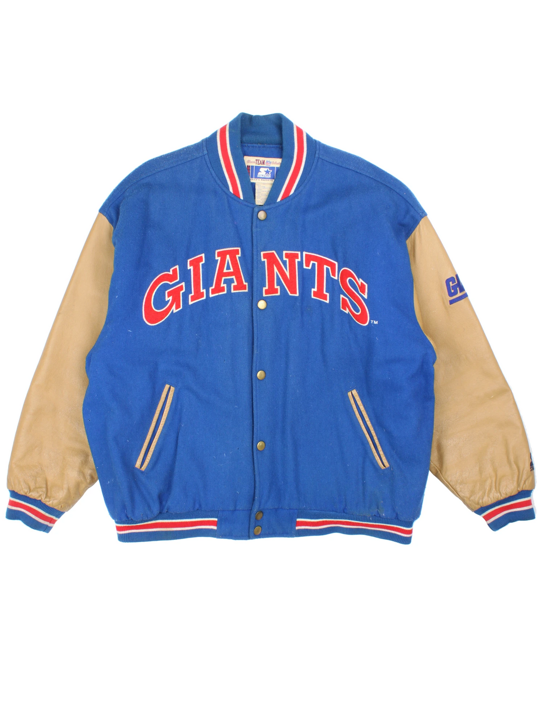 90's New York Giants varsity jacket with blue wool body and tan leather arms. Features embroidered logos on the arms and felt applique logo across the chest  good condition - Discoloration around the collar and scuffs to the leather on the arms and bobbling through out (see photos) Size in Label: Mens XL 
