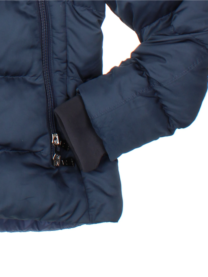 Moncler Cardere down puffer coat in a navy blue colourway. The coat has a puffer lining and the Moncler logo embroidered around the collar. There are extra thermal lined cuffs and a double zip for extra warmth.  