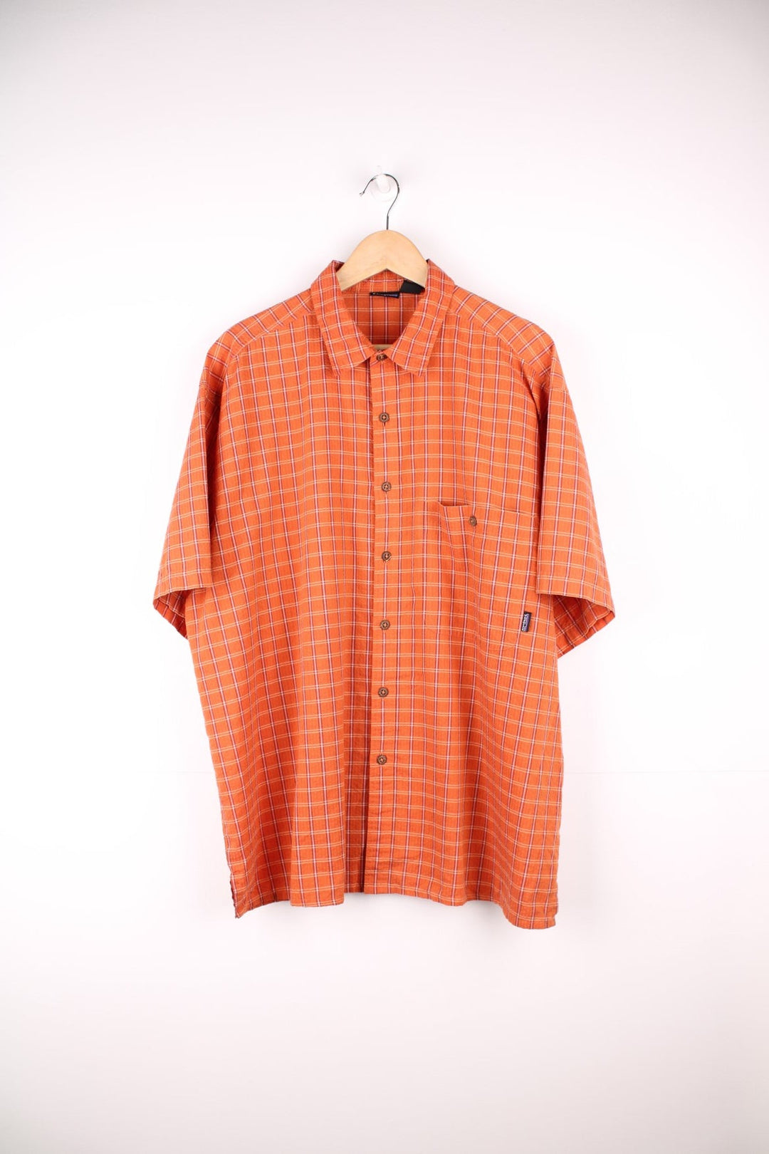 Patagonia plaid button through short sleeved shirt in orange with chest pocket and embroidered logo. 