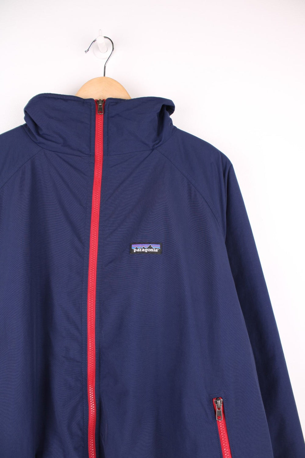 Patagonia zip through fleece lined jacket in blue and red. Features embroidered logo on the chest.