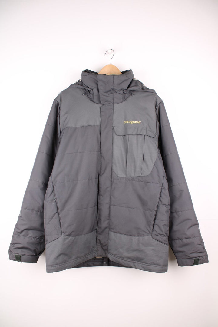 Patagonia puffer coat with printed logo on the chest and sleeve, multiple pockets and removable hood. 