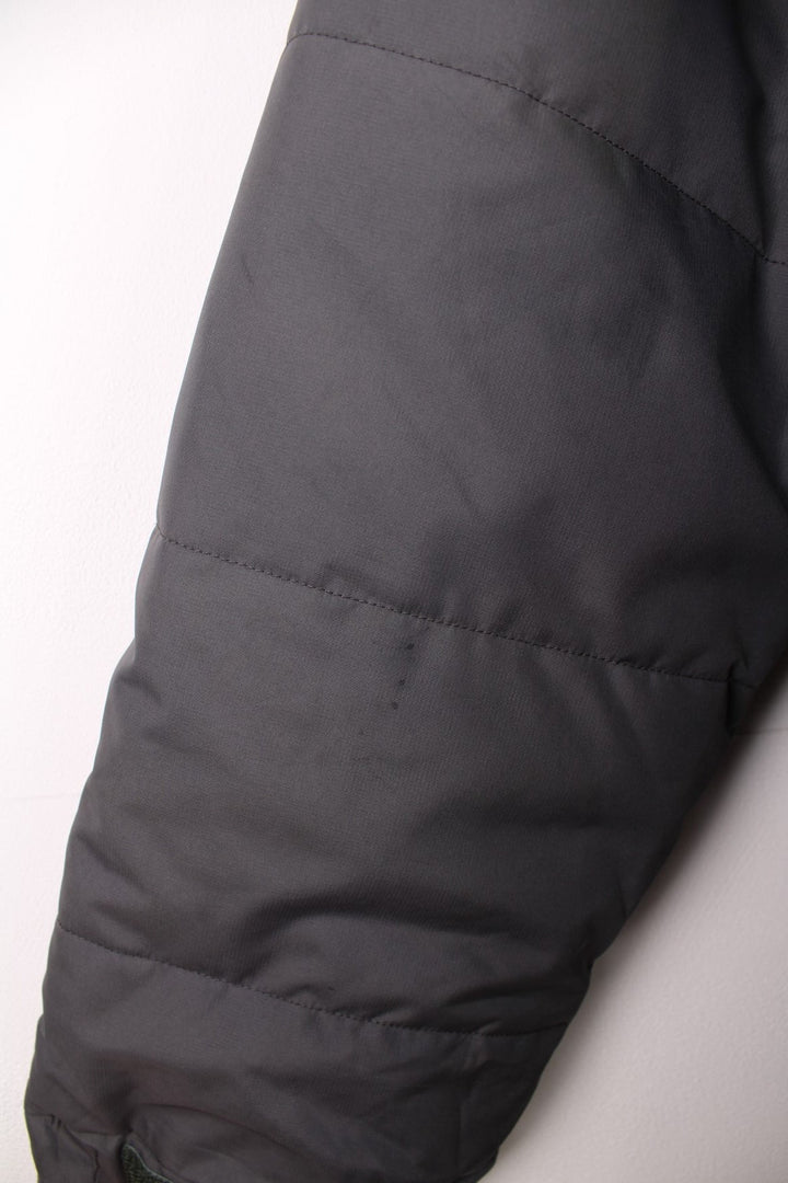 Patagonia puffer coat with printed logo on the chest and sleeve, multiple pockets and removable hood. 