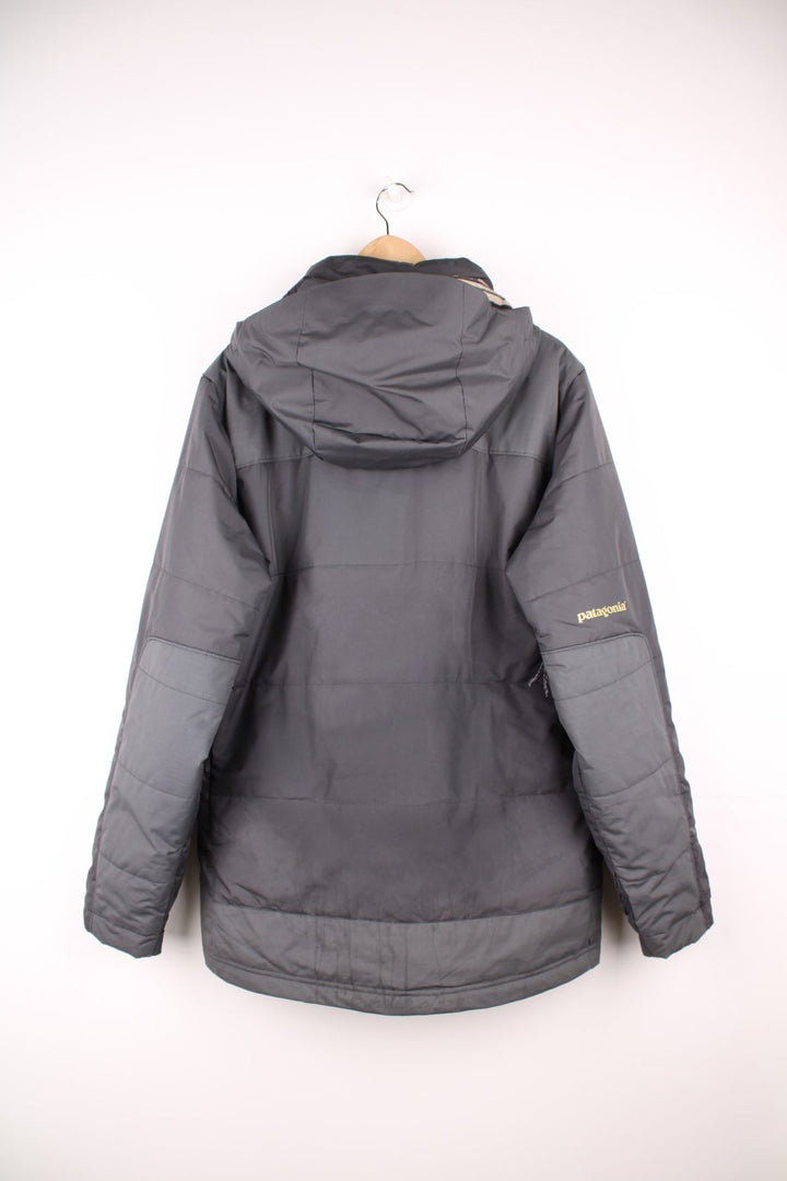Patagonia puffer coat with printed logo on the chest and sleeve, multiple pockets and removable hood. 