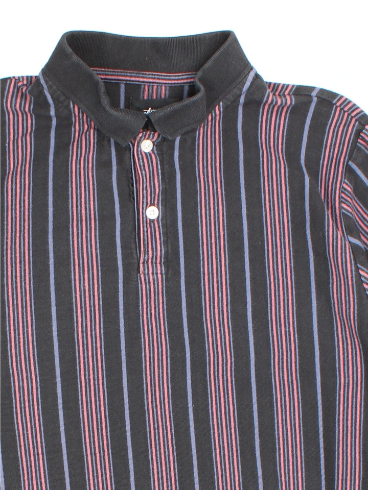 Stussy Revival Stripe Polo Shirt in a grey, black and pink colourway, button up collar with the logo embroidered on the front by the hem.