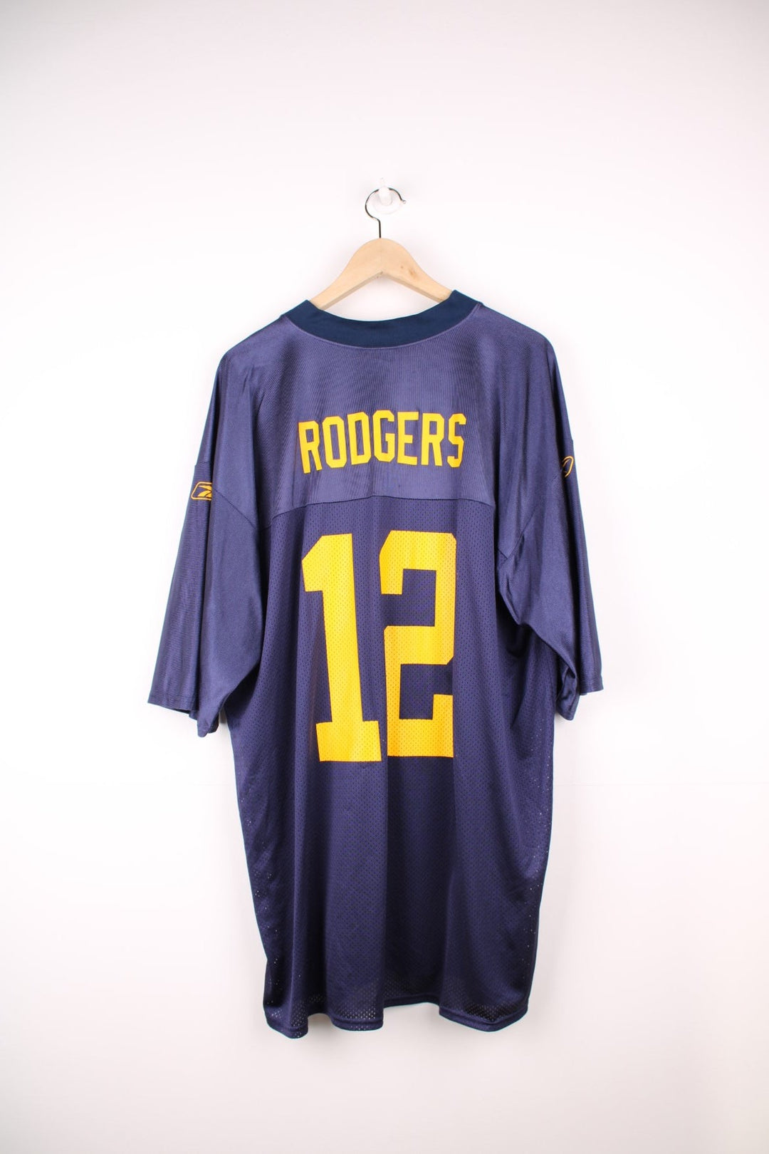 NFL Green Bay Packers Jersey in a blue and yellow colourway, Aaron Rodgers number 12 printed on the front and back, and has the logo on the sleeves.