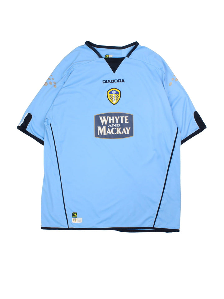 Vintage Leeds United 2004/05 Football Shirt in the blue away kit colourway, features embroidered logos and badge on the front.
