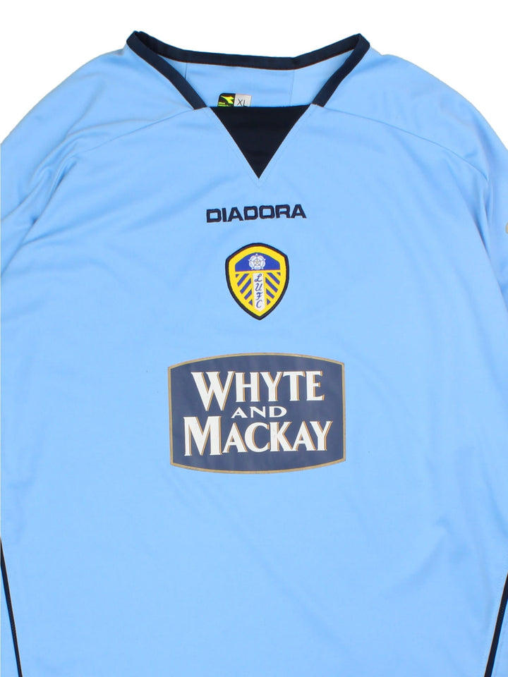 Vintage Leeds United 2004/05 Football Shirt in the blue away kit colourway, features embroidered logos and badge on the front.
