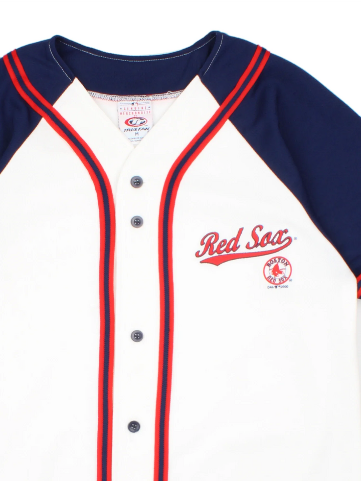 Boston Red Sox MLB Baseball Jersey in the white home kit colourway, features blue sleeve detailing and red trim on the front. Full classic button up and logo on the chest.