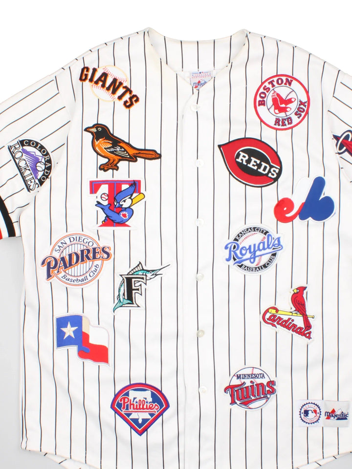 2003 All Star MLB Majestic Baseball Jersey in a white colourway, features embroidered team logo's and patches all over and classic sleeve and stripe detailing.