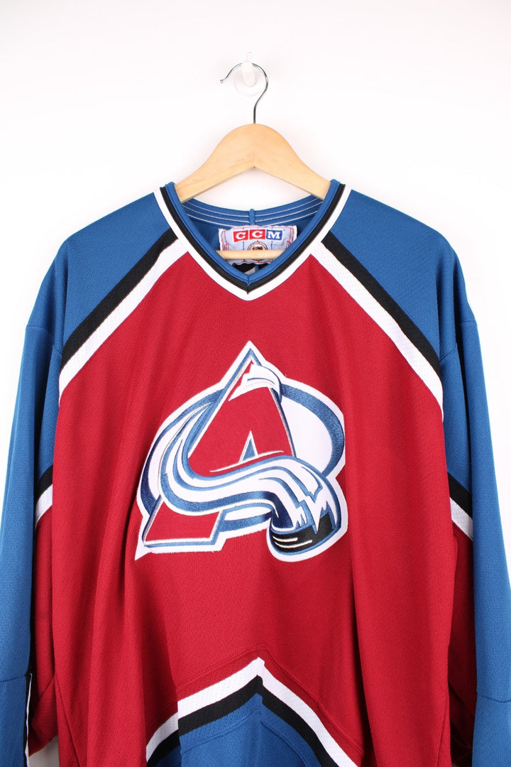 Vintage Colorado Avalanche CCM, NHL Hockey jersey in a red, white and blue colourway. 
