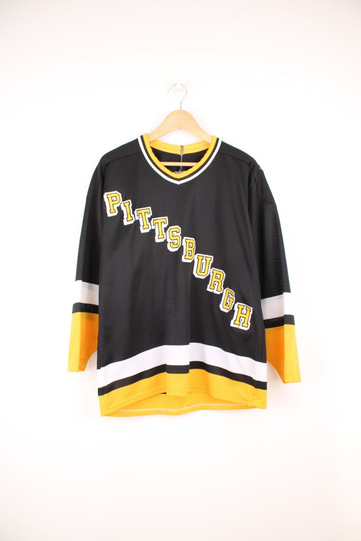 90s Pittsburgh Penguins CCM, NHL hockey jersey in a black, white and yellow colourway.