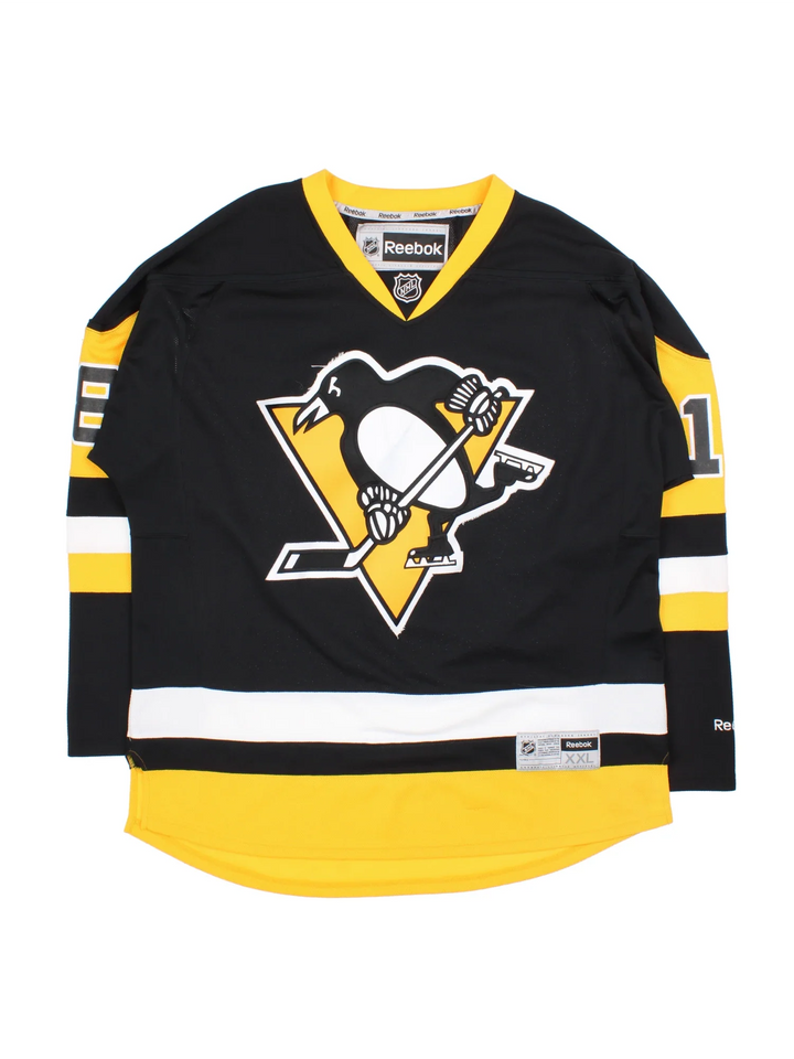 Pittsburgh Penguins Reebok NHL Jersey in the black colourway with yellow and white stripe detailing, features embroidered logos and badge on the front and player name NEAL #18 on the back.
