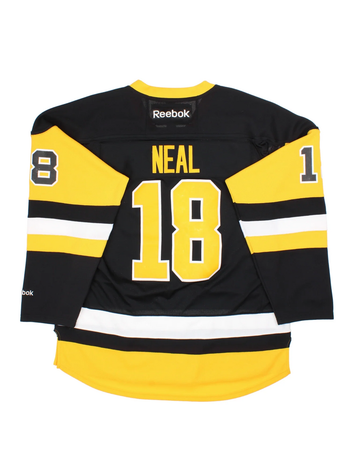 Pittsburgh Penguins Reebok NHL Jersey in the black colourway with yellow and white stripe detailing, features embroidered logos and badge on the front and player name NEAL #18 on the back.