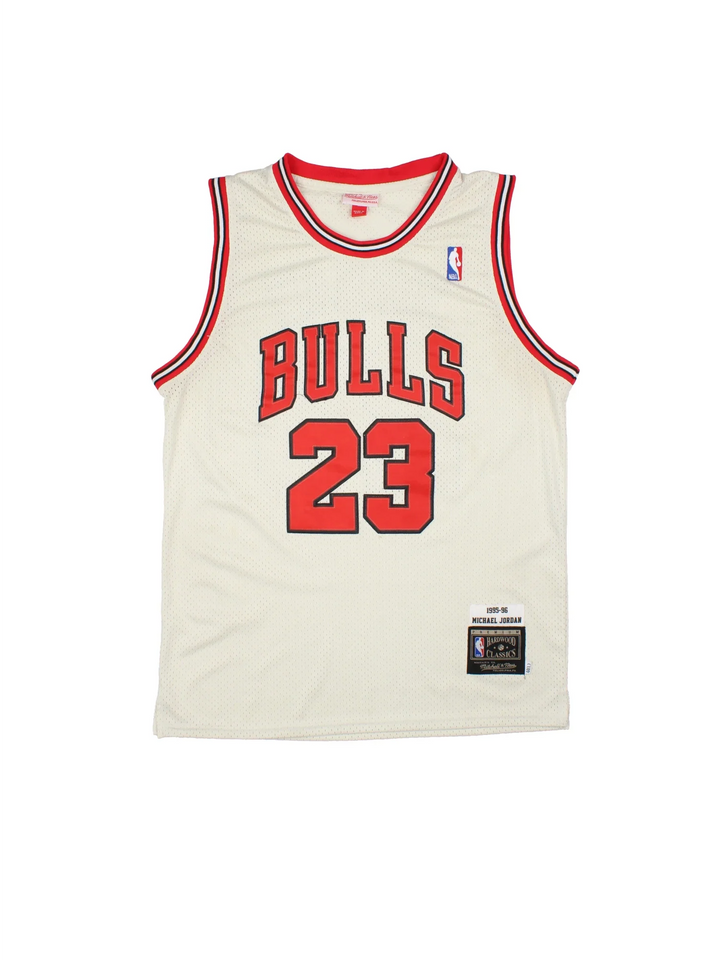 Chicago Bulls 1995-96 Michael Jordan NBA Hardwood Classic Jersey in the tan colourway with red and black trim, features embroidered logos and badge on the front and classic JORDAN #23 on the back.