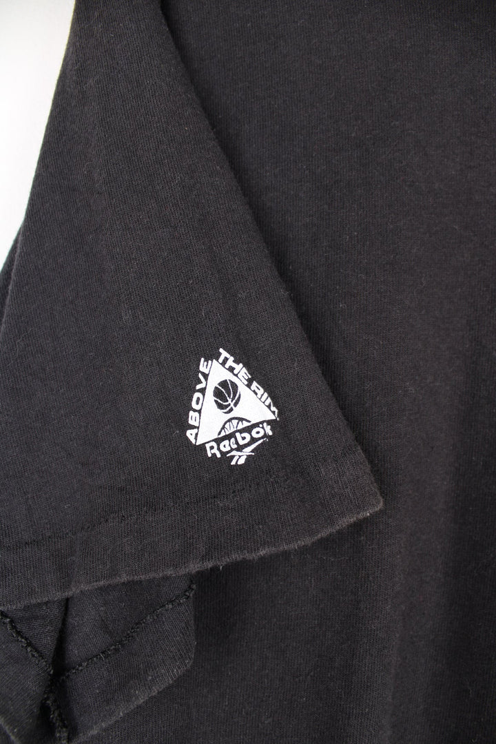 Vintage 90s Above the Rim Reebok single stitch T-Shirt with printed logo on the front and back.