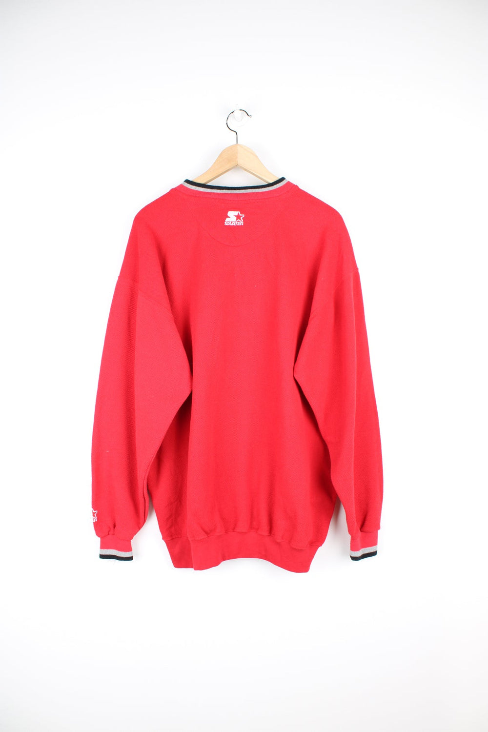 Vintage 90s Chicago Bulls v-neck sweatshirt with large embroidered logo across the chest.