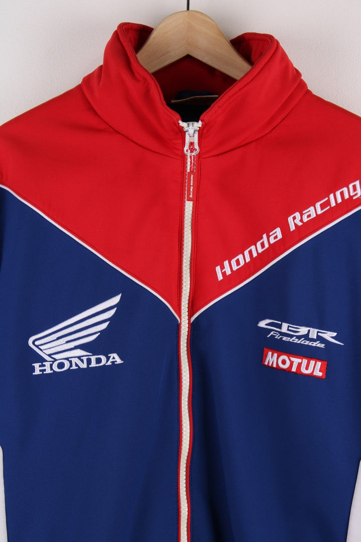  Honda Softshell Racing Jacket in a  and red colourway, zips up and has side pockets, hidden hood, and the logos embroidered all over the jacket.