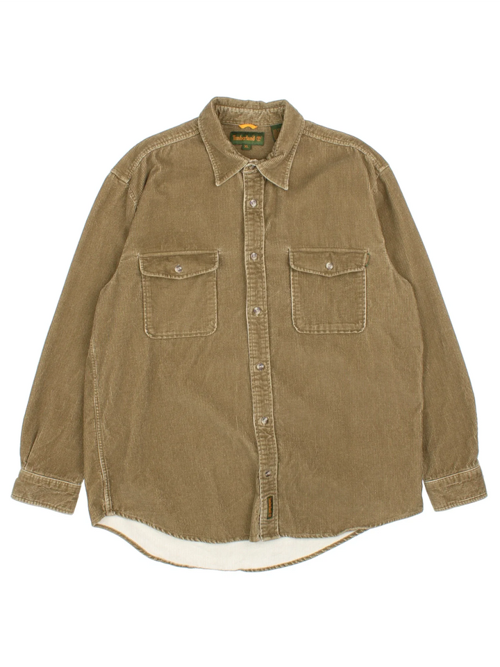 Timberland Corduroy Shirt in a brown colourway. Button up fastening, with front patch pockets and embroidered branded tab.