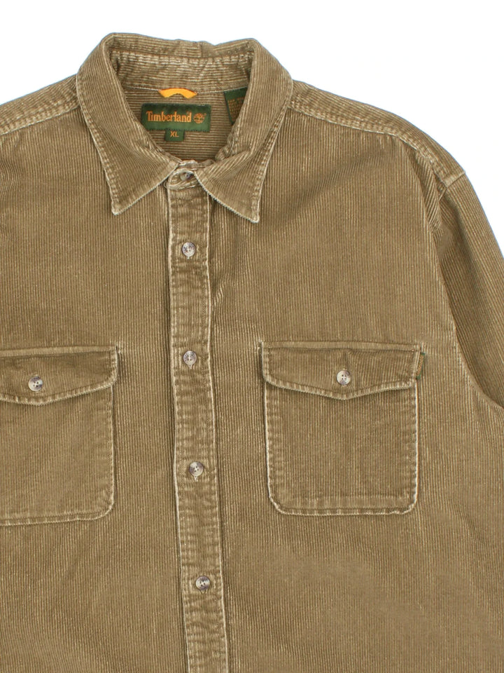 Timberland Corduroy Shirt in a brown colourway. Button up fastening, with front patch pockets and embroidered branded tab.