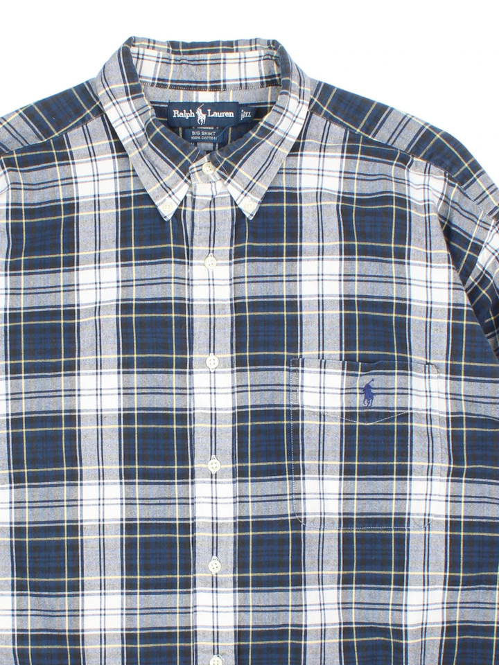 Ralph Lauren Shirt in a blue and white checked colourway, buttons up and has a chest pocket with the logo embroidered on the front.