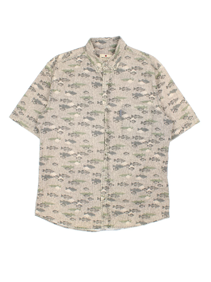 Woolrich Fish Shirt in a brown colourway, buttons up and has a chest pocket with the logo tab embroidered on the front, and all over fish print.
