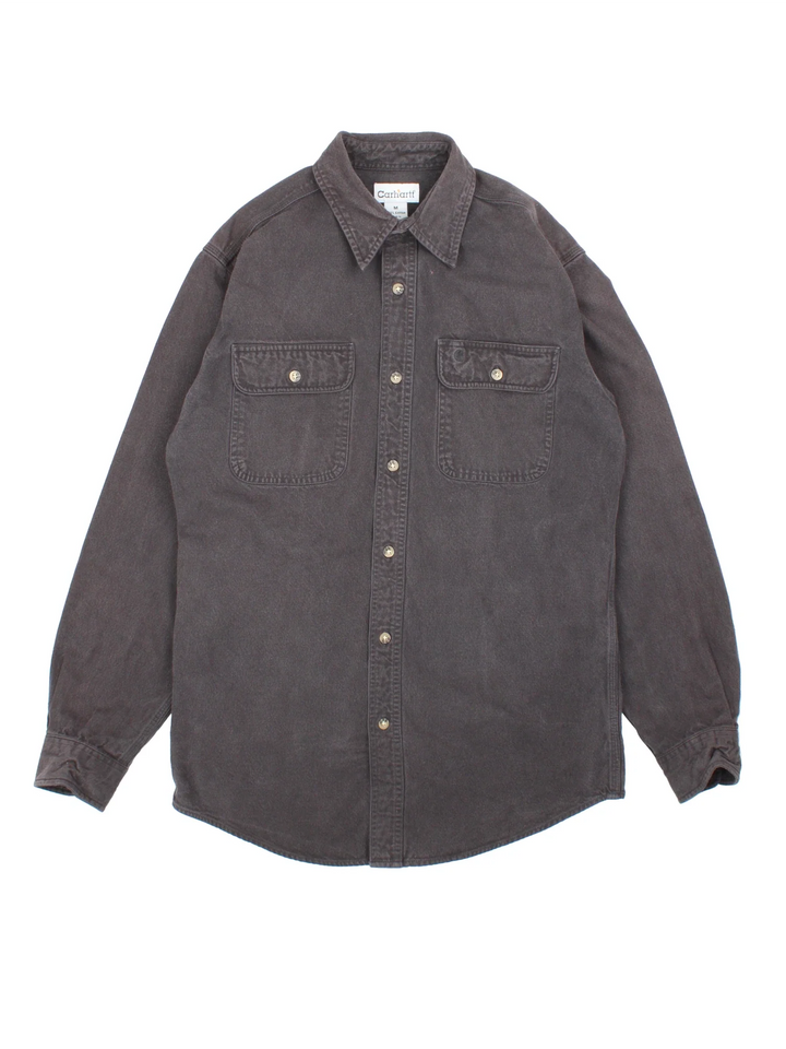 Carhartt Heavy Work Shirt in a black colourway, buttons up and has double chest pockets with the logo embroidered on the front.