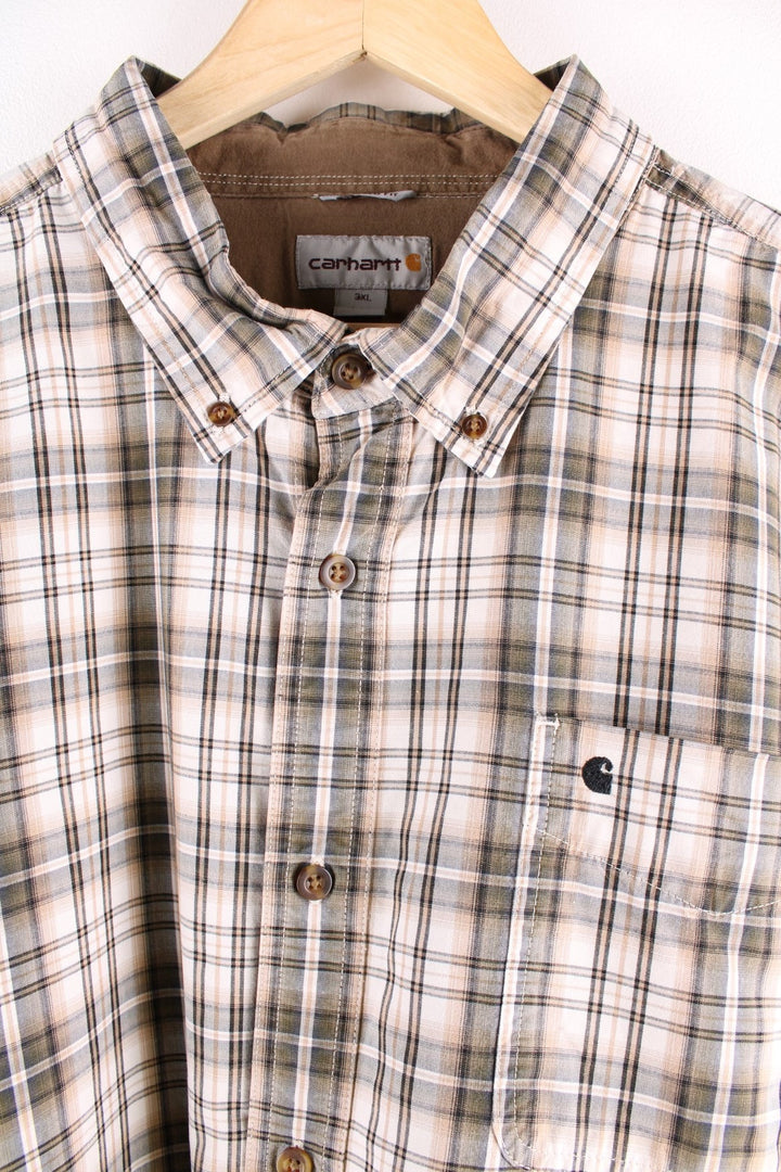 Carhartt button-down shirt in tan and grey check, with one breast pocket and a small C logo embroidered in black.