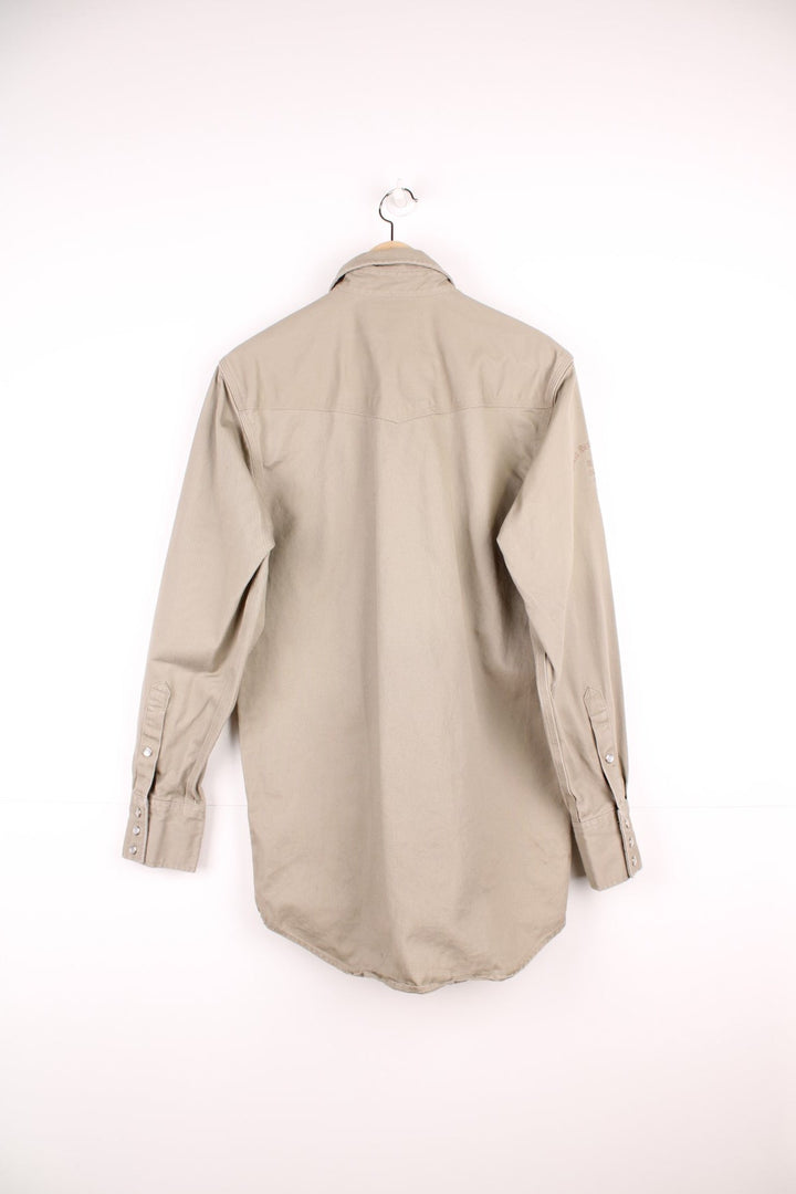 Carhartt western style shirt with pearl snap fastenings and Great Northern Classic, Rodeo Champion Barrels 2015 embroidery on the sleeve. 
