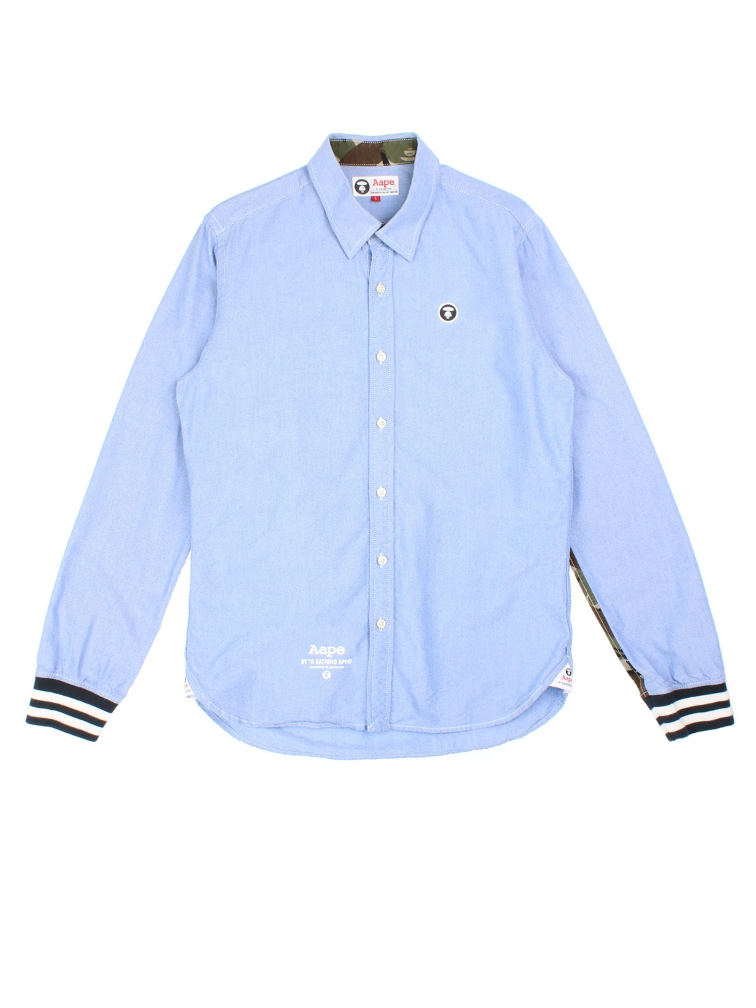 A Bathing Ape By Bape Oxford Shirt in a blue colourway and has camo panelling by on the sleeves, button up with the logo embroidered on the front.
