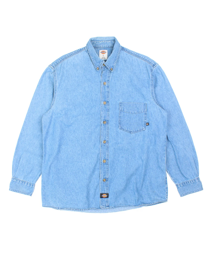 Dickies Denim Shirt in a blue colourway, button up and has a chest pocket with the logo embroidered on the front.
