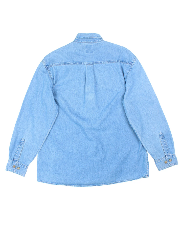 Dickies Denim Shirt in a blue colourway, button up and has a chest pocket with the logo embroidered on the front.