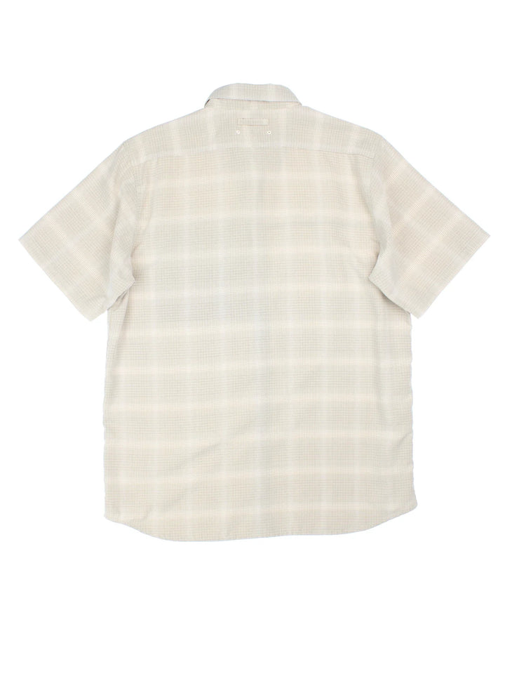 The North Face Shirt in a tan colourway and plaid pattern all over, button up and has a chest pocket with the logo embroidered on the front.