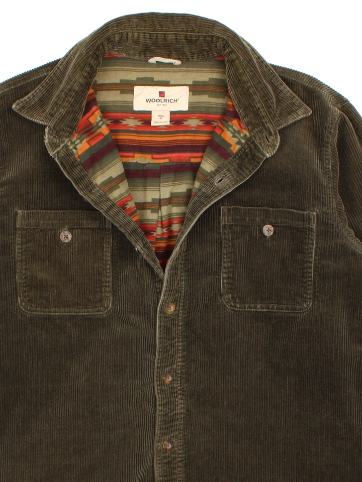 Woolrich Corduroy Shirt in a green colourway, aztec pattern lining, button up and has double chest pockets.