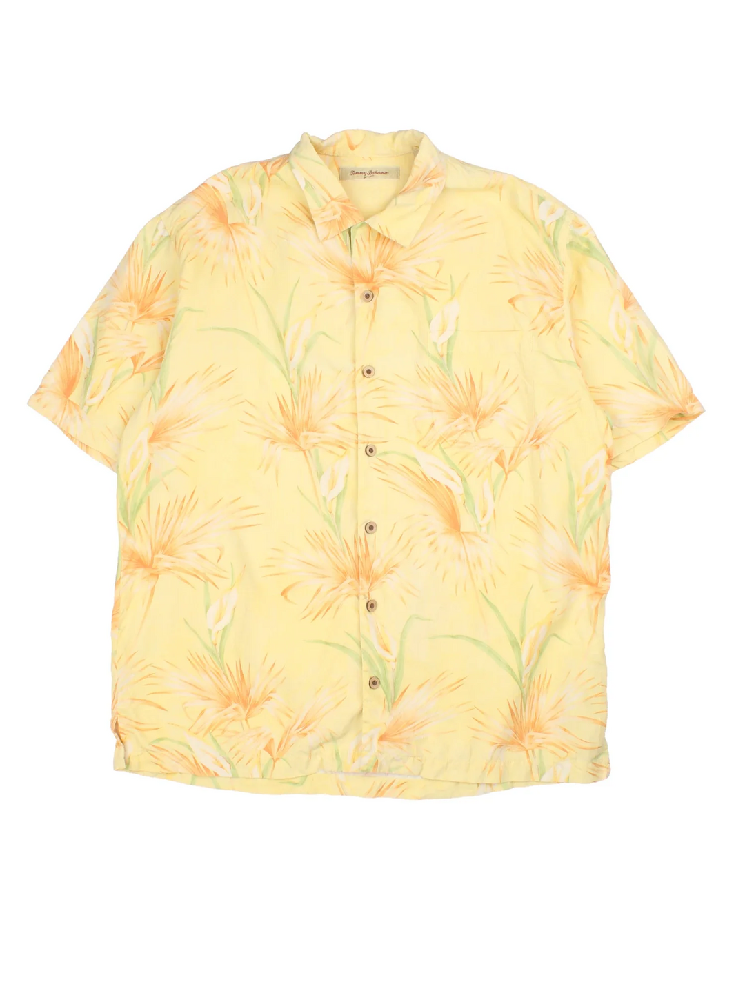 Tommy Bahama Hawaiian Shirt in a yellow colourway, buttons up and has a chest pocket on the front, and floral patterns printed all over.
