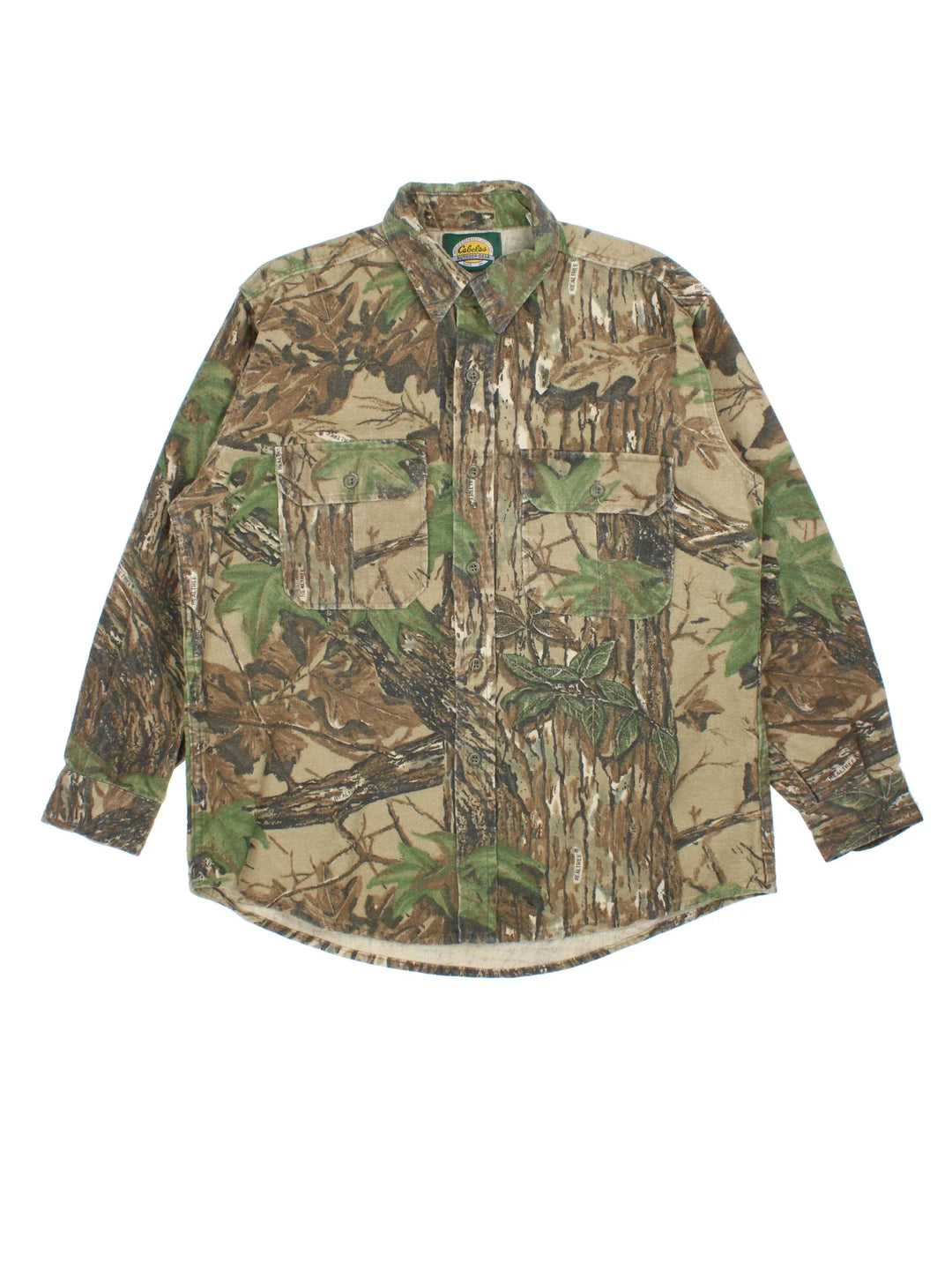 Vintage Cabelas Real Tree Camo Shirt in a green and brown patterned colourway, buttons up and has double chest pockets on the front.