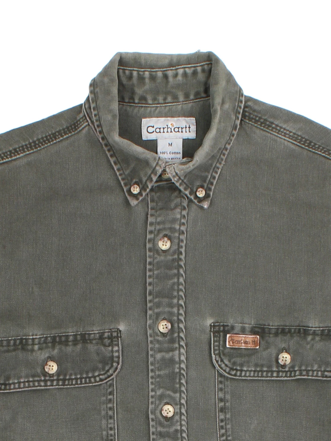 Carhartt Work Shirt in a khaki green colourway, buttons up and has double chest pockets with the logo embroidered on the front.