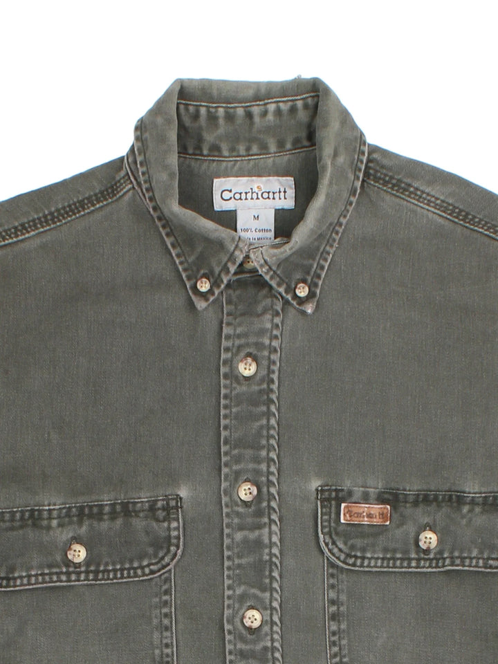 Carhartt Work Shirt in a khaki green colourway, buttons up and has double chest pockets with the logo embroidered on the front.