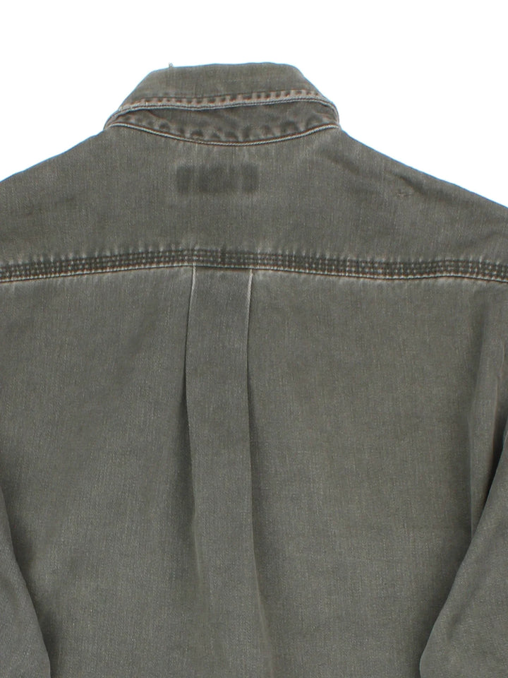 Carhartt Work Shirt in a khaki green colourway, buttons up and has double chest pockets with the logo embroidered on the front.