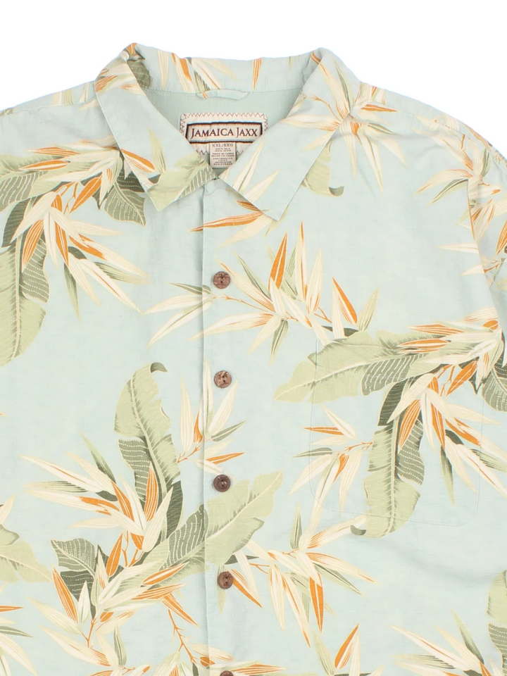 Vintage Floral Hawaiian Shirt in a blue colourway, buttons up and has a chest pockets, and floral patterns printed all over.