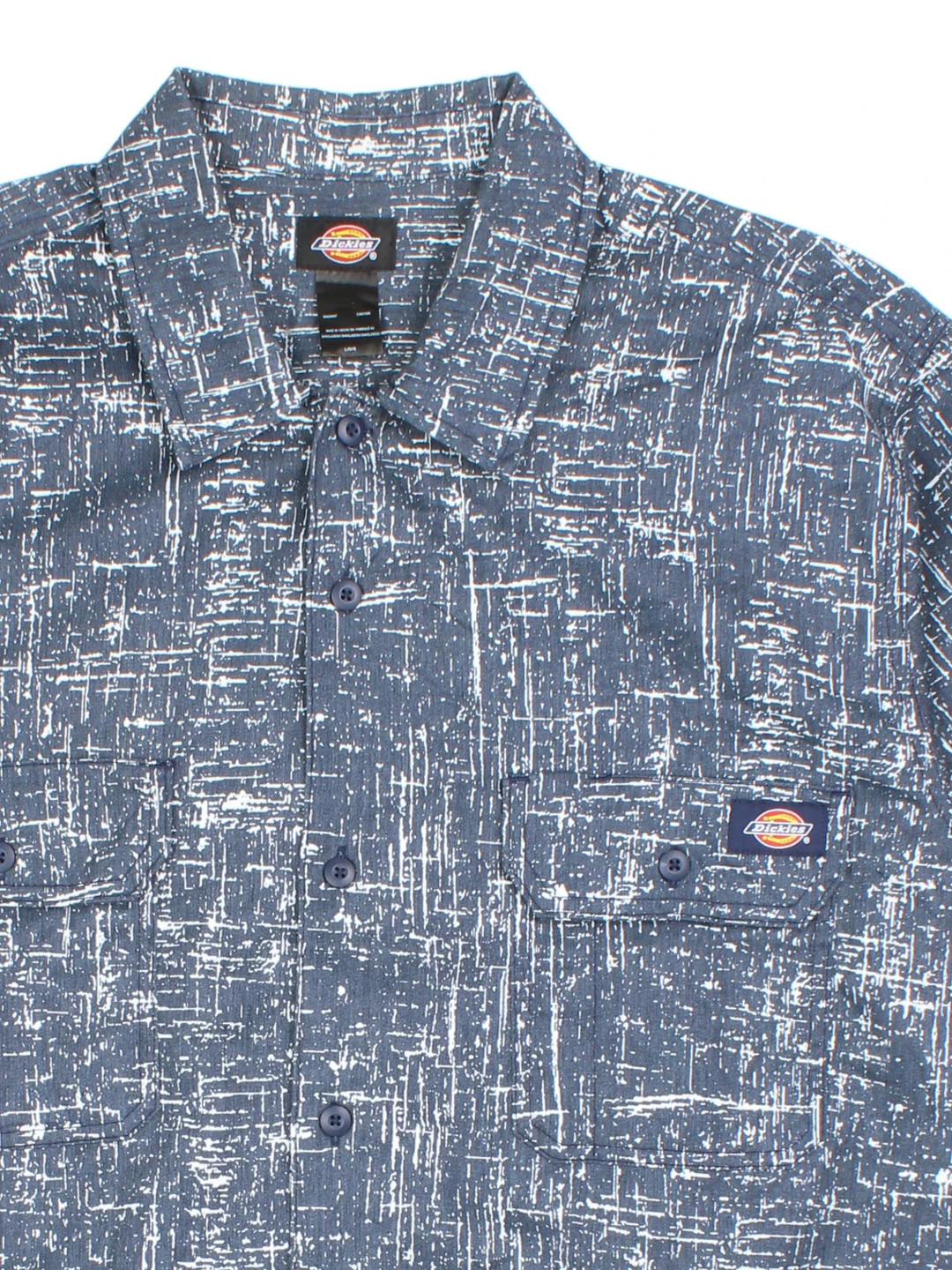 Dickies Work Shirt in a blue and white patterned colourway, buttons up and has double chest pockets with the logo embroidered on the front.